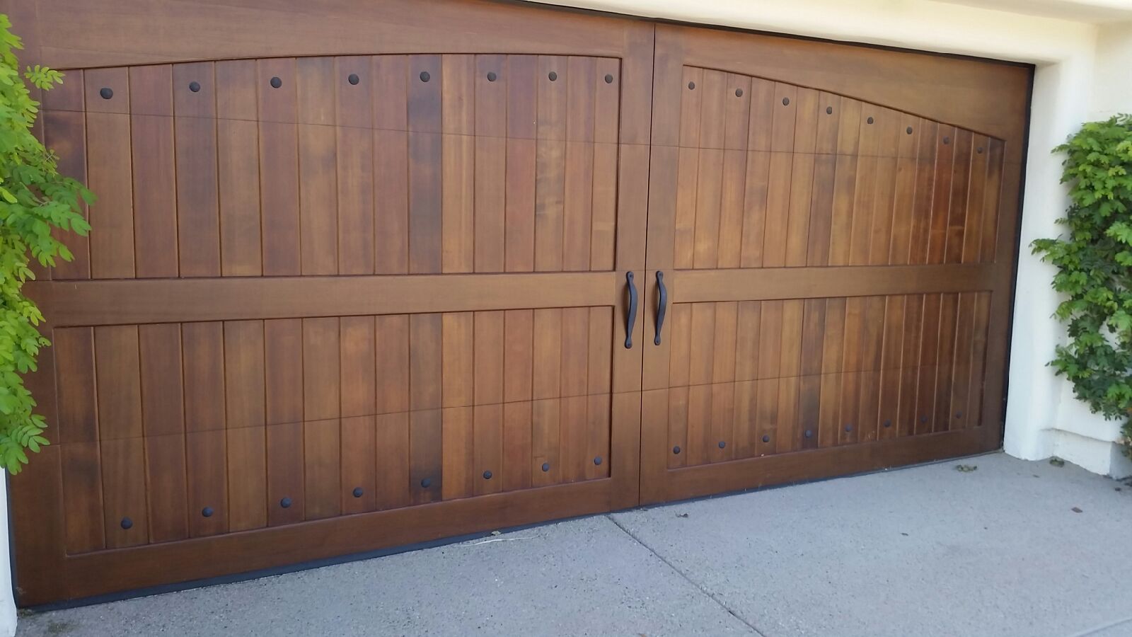 Arched Design Wood Garage Door With Ornamental Hardware And